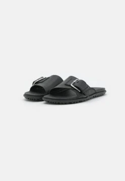 Ugg SOLIVAN BUCKLE SLIDE - Pantolette Flach - Black -Ugg 5153019481d449fcbbd357af512384a0